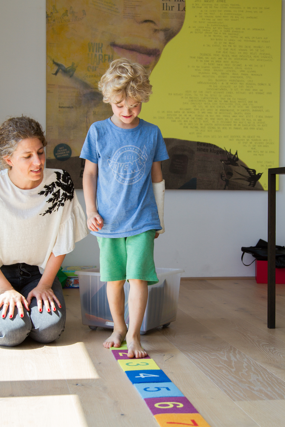 Bub mit blauem T-Shirt geht auf einer Zahlenreihe